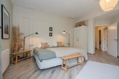 a bedroom with a large bed and a table at The Collection Barcelona - Luxury 4-bedrooms in Rambla de Catalunya in Barcelona