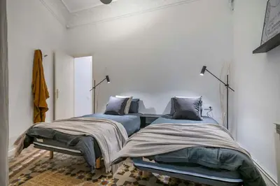 a bedroom with two beds and a window at The Collection Barcelona - Elegant 4 bedrooms 3 bathrooms Catalan home in Barcelona