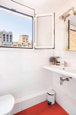 a bathroom with a white toilet and a shower at The Collection Barcelona - Pl Universitat Bright and cozy 2BD - 2BTH in Barcelona