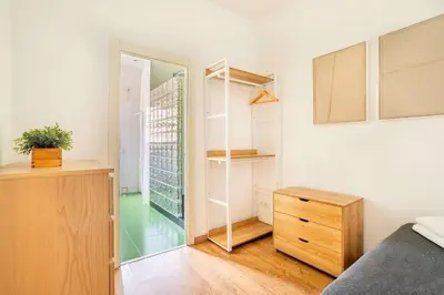 a small bedroom with a bed and a closet at The Collection Barcelona - Pl Universitat Bright and cozy 2BD - 2BTH in Barcelona