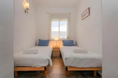 two twin beds in a room with a window at The Collection Barcelona -3BD with private terrace right by Sagrada Familia in Barcelona