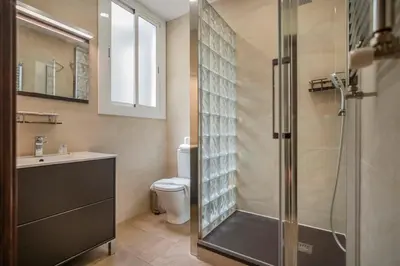 a shower with a glass door in a bathroom at The Collection Barcelona -3BD with private terrace right by Sagrada Familia in Barcelona