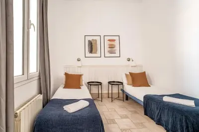 a kitchen with a table with chairs and a television at The Collection Barcelona - Historic apartment with private terrace in Example in Barcelona