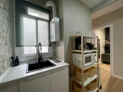 a small kitchen with a sink and a microwave at The Collection Barcelona - Poble Sec - Modern & comfy 3 bedrooms in Barcelona