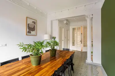 a dining room with a wooden table and potted plants at The Collection Barcelona - Exclusive Luxe Design - Large Tranquil Penthouse in Barcelona