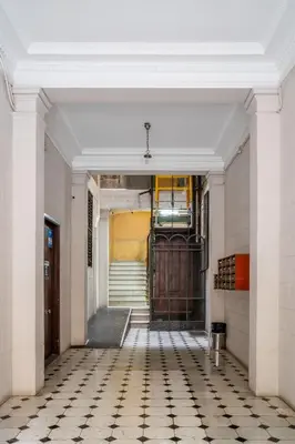 a hallway with a door and a tiled floor at The Collection Barcelona - Ronda Sant Pere in Barcelona