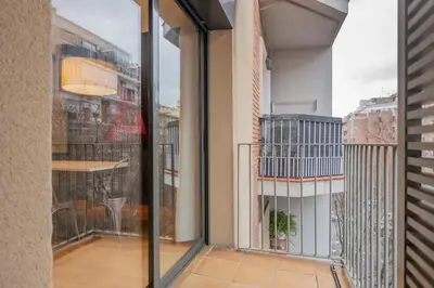 a living room with a couch and a table and chairs at The Collection Barcelona - 2 bedroom Duplex apartment with balcony 4-3 in Barcelona