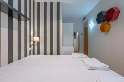 a bedroom with a bed and a window in it at The Collection Barcelona - 2 bedroom Duplex apartment with balcony 4-3 in Barcelona