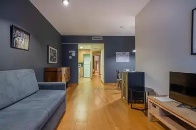 a living room with a couch and a flat screen tv at The Collection Barcelona - 2 bedroom with balcony in Eixample 4-2 in Barcelona