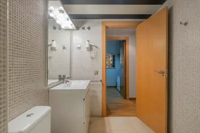 a kitchen with a microwave and a washer and dryer at The Collection Barcelona - Modern and bright apartment in Eixample 5-1 in Barcelona