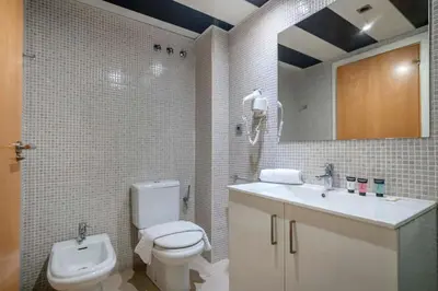 a bathroom with a shower and a toilet and a sink at The Collection Barcelona - Modern and bright apartment in Eixample 5-2 in Barcelona