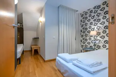 a hotel room with a bed with towels on it at The Collection Barcelona - Bright and modern Duplex with terrace in Eixample district P2 in Barcelona