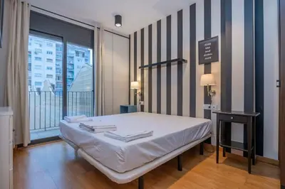 a living room with a couch and a table at The Collection Barcelona - 2 bedroom with balcony in Eixample 1-1 in Barcelona