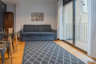 an apartment balcony with a view of buildings at The Collection Barcelona - 2 bedroom with balcony in Eixample 1-1 in Barcelona