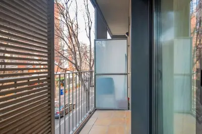 a glass door to a balcony with a view at The Collection Barcelona - Modern and bright apartment in Eixample 1-3 in Barcelona
