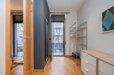 a room with white walls and a hallway with a door at The Collection Barcelona - Modern and bright apartment in Eixample 1-3 in Barcelona