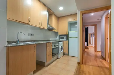 a kitchen with a sink and a stove at The Collection Barcelona - 2 bedroom with balcony in Eixample 3-2 in Barcelona