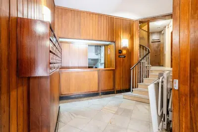 a hallway with wood paneled walls and a staircase at The Collection Barcelona - Big apartment for 15 in the heart of Eixample in Barcelona