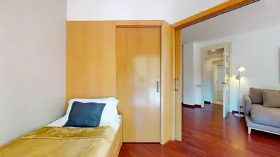 a small bedroom with a bed and a couch at The Collection Barcelona - Modern and bright three-bedroom in Eixample in Barcelona
