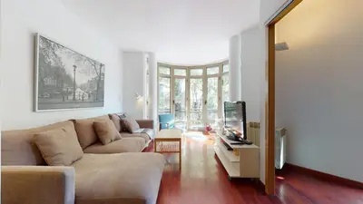 a living room with a couch and a tv at The Collection Barcelona - Modern and bright three-bedroom in Eixample in Barcelona