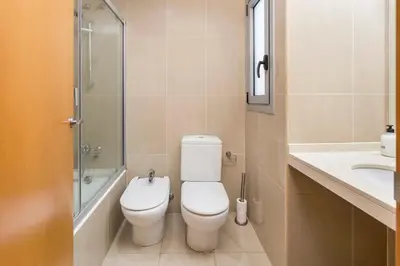 a bathroom with a toilet and a sink and a shower at The Collection Barcelona - Spacious and Elegant 4 Bedroom with Private Terrace in Barcelona