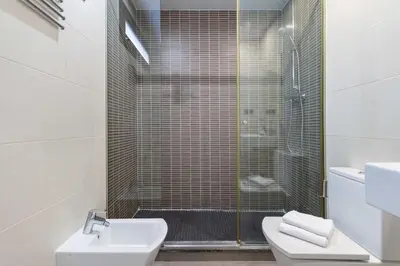 a bathroom with a shower and a toilet and a sink at The Collection Barcelona - Sunny Atico with Terrace in Pl Universitat! in Barcelona
