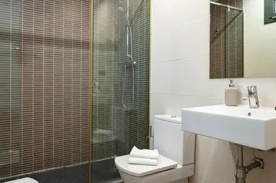 a bathroom with a shower and a toilet and a sink at The Collection Barcelona - Sunny Atico with Terrace in Pl Universitat! in Barcelona