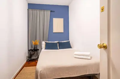 a bedroom with blue walls and a bed with blue pillows at The Collection Barcelona - Next to Sagrada Familia 4-bedroom Apartment in Barcelona