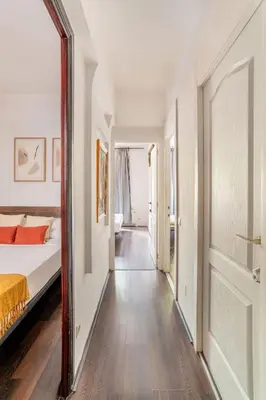 a bedroom with a bed and a mirror at The Collection Barcelona - 4- Bedroom Apartment in Gracia Village in Barcelona