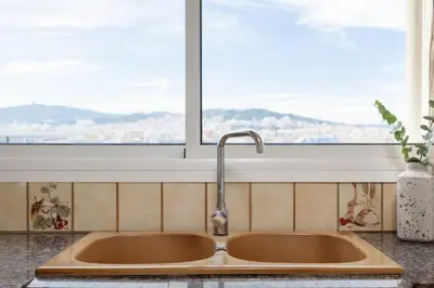 a sink in a kitchen with a window at The Collection Barcelona - City View Penthouse - 2 Bedroom Suite in Barcelona