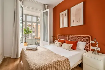 a bedroom with orange walls and a bed with orange pillows at The Collection Barcelona - Gorgeous 4bed 4bath close to City Center in Barcelona