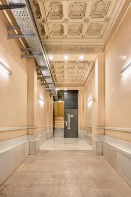 an empty hallway with a door in a building at The Collection Barcelona - Perfectly located 4bed 4bath apartment in Eixample in Barcelona