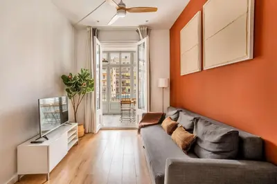 a living room with a couch and a television at The Collection Barcelona - Very Spacious Eixample 4bd 4ba apartment in Barcelona