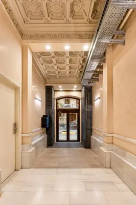 an empty hallway in a building with a ceiling at The Collection Barcelona - Very Spacious Eixample 4bd 4ba apartment in Barcelona