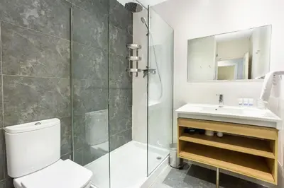a bathroom with a sink and a shower at The Collection Barcelona - 4bedroom apartment with a balcony in Las Ramblas 1 2 in Barcelona