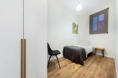 a living room with a couch and a tv and a table at The Collection Barcelona - Centric 3bedroom in Las Ramblas 2 1B in Barcelona