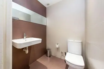 a bathroom with a white toilet and a sink at The Collection Barcelona - 4bedroom apart with balcony in Las Ramblas 3-2 in Barcelona