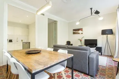 a living room with a table and a couch at The Collection Barcelona - 4bedroom apart with balcony in Las Ramblas 3-2 in Barcelona