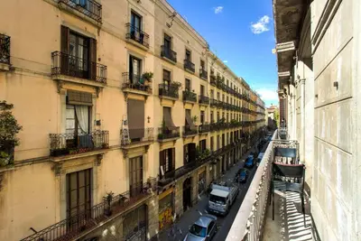 a city street with cars parked on the side of buildings at The Collection Barcelona - 4bedroom apart with balcony in Las Ramblas 3-2 in Barcelona