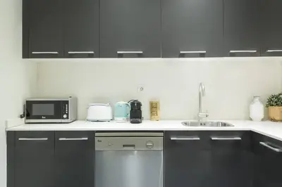 two beds sitting next to each other in a room at The Collection Barcelona - Bright and modern 4bedroom with terrace in Las Ramblas P1 in Barcelona