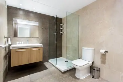 a white bedroom with a bed and a desk at The Collection Barcelona - Bright and modern 3bedroom in Las Ramblas 3 1B in Barcelona