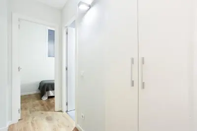 a hallway with white cabinets and a bed in a room at The Collection Barcelona - Bright and modern 2bedroom in Las Ramblas 2 1A in Barcelona