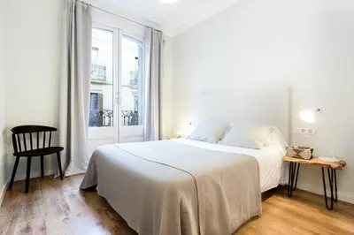 a bathroom with a bed and a sink and a mirror at The Collection Barcelona - Bright and modern 2bedroom in Las Ramblas 2 1A in Barcelona