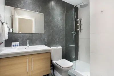 a bathroom with a toilet and a sink and a shower at The Collection Barcelona - Bright and modern 2bedroom in Las Ramblas 2 1A in Barcelona