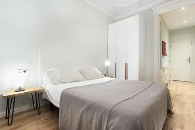 a quotationatory logo with a magnifying glass at The Collection Barcelona - Bright and modern 2bedroom in Las Ramblas 2 1A in Barcelona