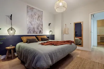 a bedroom with a large bed with a blanket on it at The Collection Barcelona - Plaza Catalunya cozy 4 Bedroom in Barcelona