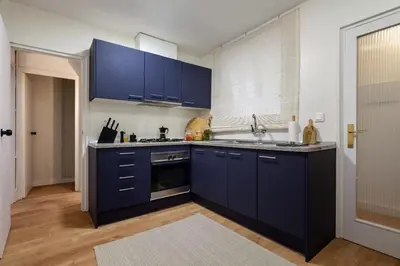 a kitchen with blue cabinets and a sink at The Collection Barcelona - Plaza Catalunya cozy 4 Bedroom in Barcelona
