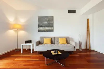 a living room with a couch and a table at The Collection Barcelona - Plaça Catalunya Modern 2bedroom with balcony in Barcelona
