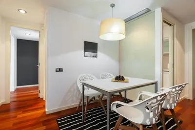 a table and two chairs on a balcony with a view at The Collection Barcelona - Plaça Catalunya Modern 2bedroom with balcony in Barcelona