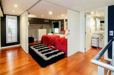 a bedroom with a red bed and a black and white rug at The Collection Barcelona - Luxury Duplex Apartment in the Heart of Barcelona in Barcelona